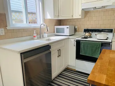 a kitchen with a sink and a microwave at 2 Beds Guest Suite to Yourself at Coquitlam Centre Mall in Port Coquitlam
