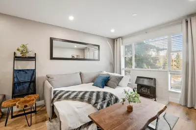 a living room with a couch and a fireplace at Ski In & Out, Heart of Upper Village in Whistler