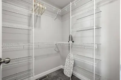 a walk in shower with white shelves in a bathroom at Large House Near Calgary Airport with Central AC, Double Car Garage Parking, Upgrade Stay, Netflix, Sleeps 8 in Calgary