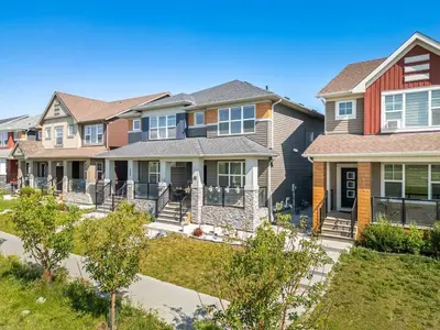 a row of houses in a residential neighborhood at Large House Near Calgary Airport with Central AC, Double Car Garage Parking, Upgrade Stay, Netflix, Sleeps 8 in Calgary