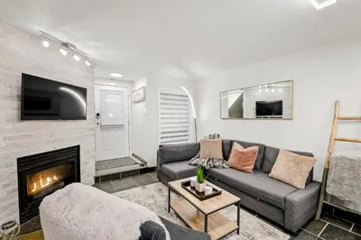 a living room with a couch and a fireplace at Whistler Village, Private Hot Tub, Free Parking in Whistler