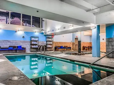 an indoor swimming pool in a building at L109 Canmore World Class Solara Resort - Hot tub, Pool, Gym, AirCon, Free Parking & Netflix in Canmore