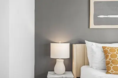 a bedroom with a bed and a lamp on a table at B233 Mountain View 2BD 2BT AC BonFire BBQ Townhome Close to Banff in Canmore