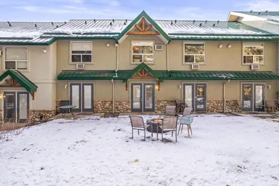 a house with a table and chairs in the snow at B233 Mountain View 2BD 2BT AC BonFire BBQ Townhome Close to Banff in Canmore