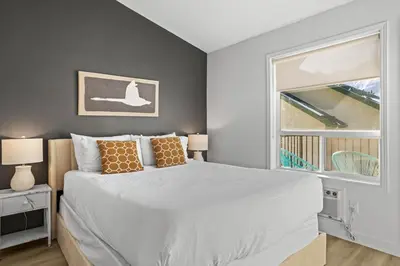 a bedroom with a large bed and a window at B233 Mountain View 2BD 2BT AC BonFire BBQ Townhome Close to Banff in Canmore