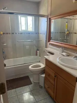 a bathroom with a toilet and a sink and a shower at Big band home in Burnaby