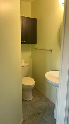 a bathroom with a toilet and a sink at Big band home in Burnaby