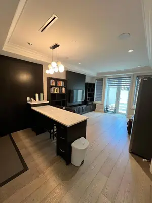 a large living room with a desk and a table at Private Rooms in Vancouver West in Vancouver