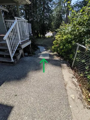 a pathway with a green arrow pointing to a house at Charming 3 Bedroom Suite in Victoria