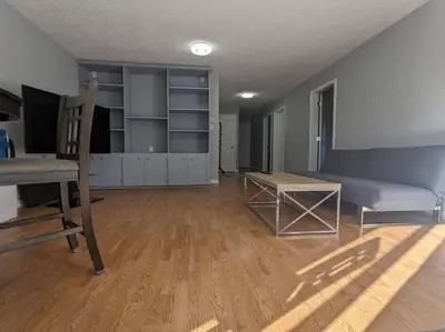 a living room with a couch and a table at Charming 3 Bedroom Suite in Victoria