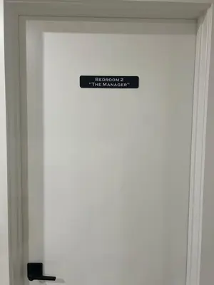 a sign on the door of a building at The Old Trafford - Stylish 2 bed suite in Calgary