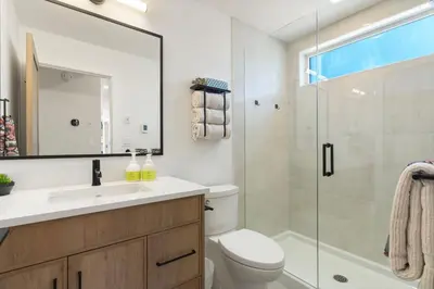 a bathroom with a shower and a toilet and a sink at Luxe Retreat by Canadian Rockies Vacation Rentals in Canmore
