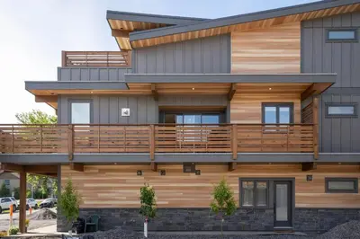 a house with wooden balconies on it at Luxe Retreat by Canadian Rockies Vacation Rentals in Canmore