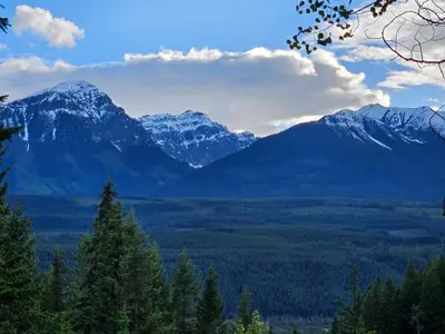 a view of a mountain range with snow covered mountains at Zest Campers Ltd in Golden