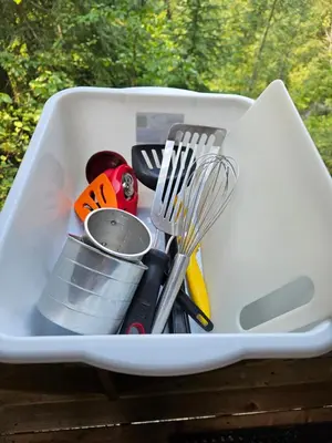 a white container filled with cooking utensils at Zest Campers Ltd in Golden