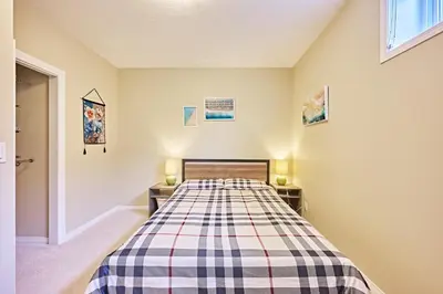 a bedroom with a bed and two night stands at sweet home in Calgary