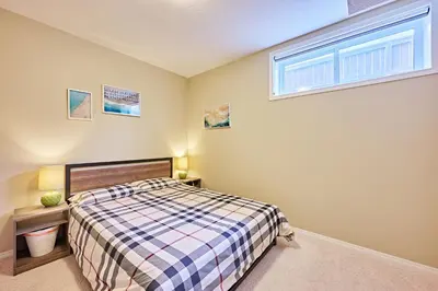 a bedroom with a bed and a window at sweet home in Calgary