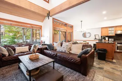 a living room with a couch and a table at Montebello 4877 by Outpost Whistler in Whistler