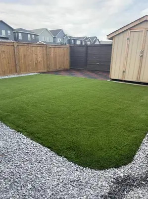 a backyard with a fence and a grass yard at Parkside Luxury Stay with Xbox Entertainment in Calgary