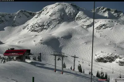 a snow covered mountain with a ski lodge on a ski slope at Whistler Highcamp in Whistler