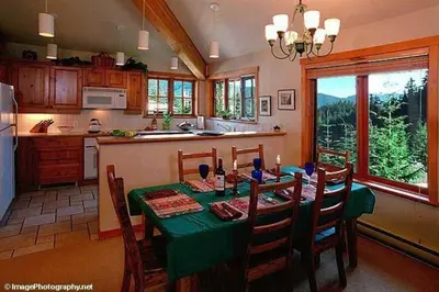 a kitchen with a table with a green table cloth at Whistler Highcamp in Whistler