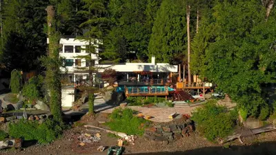 an aerial view of a house in the woods at Ozarks Luxurious Lakeside Villa at Harrison Lake in Harrison Hot Springs