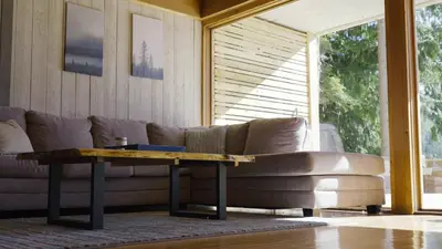 a living room with a couch and a coffee table at Ozarks Luxurious Lakeside Villa at Harrison Lake in Harrison Hot Springs