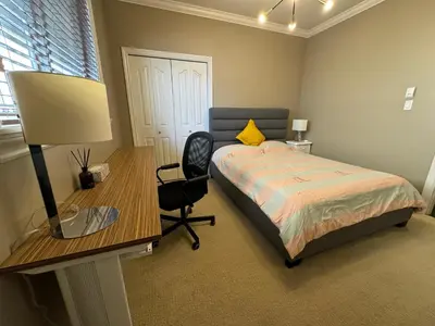 a bedroom with a bed and a desk and a chair at Zp Home in Richmond