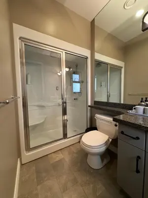 a bathroom with a toilet and a glass shower at Zp Home in Richmond