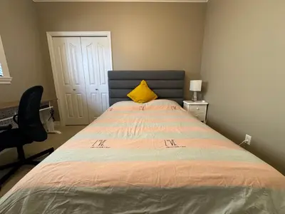a bedroom with a bed with a yellow pillow on it at Zp Home in Richmond