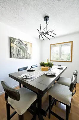 a dining room with a black table and chairs at Cozy House in Haines Junction in Haines Junction