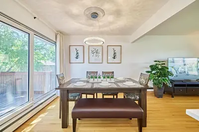 a dining room with a table and chairs at Chinook Executive Entire House in Calgary
