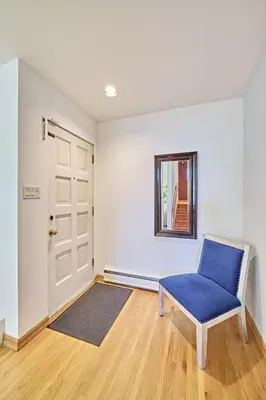 a room with a blue chair and a door at Chinook Executive Entire House in Calgary