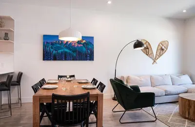 a living room with a table and a couch at Rustic Retreat by Revelstoke Vacations in Revelstoke
