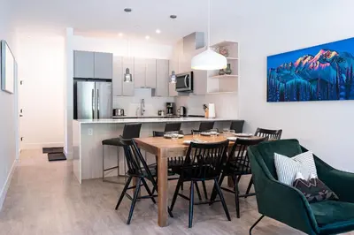 a kitchen and dining room with a table and chairs at Rustic Retreat by Revelstoke Vacations in Revelstoke