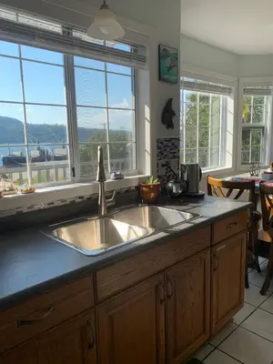 a kitchen with a sink and some windows at Best Bed and Breakfast in Port Alberni