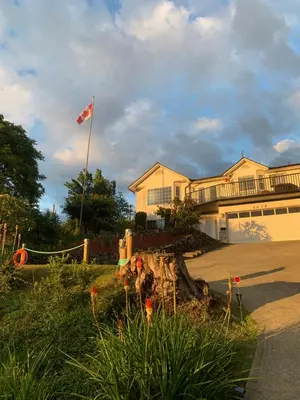a house with a flag flying in the yard at Best Bed and Breakfast in Port Alberni