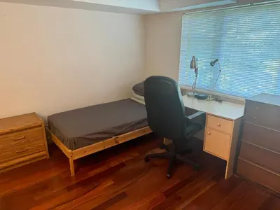a bedroom with a desk and a bed and a desk chair at Cozy and Friendly Home Single Room No Pets Allowed in Burnaby