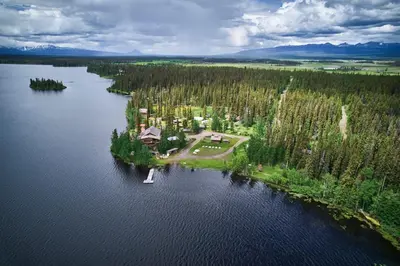 an aerial view of a house on an island in a lake at Escott Bay Resort in Anahim Lake