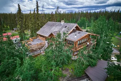 an overhead view of a large wooden house in the woods at Escott Bay Resort in Anahim Lake