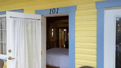 a house with a room with a bed in it at Seine Boat Inn in Alert Bay