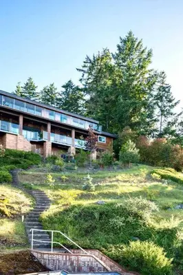 a building on a hill with a staircase in front of it at OCEAN FRONT 2 BEDROOM SUITE with STUNNING VIEWS in Victoria