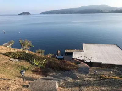 a view of a large body of water with a dock at Ocean Front Retreat with Stunning Water Views in Victoria