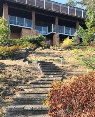 a set of stairs in front of a building at Ocean Front Retreat with Stunning Water Views in Victoria