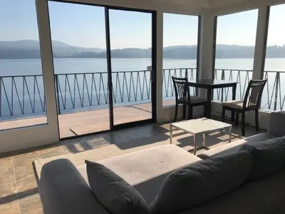 a living room with a couch and a view of the water at Ocean Front Retreat with Stunning Water Views in Victoria