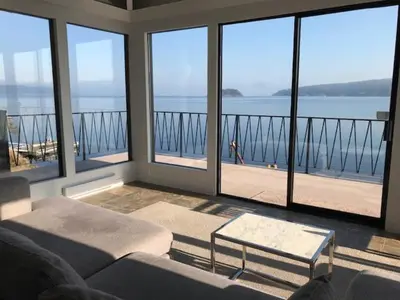a living room with a view of the water at Ocean Front Retreat with Stunning Water Views in Victoria