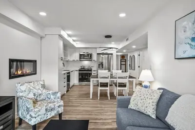 a living room with a couch and a dining room at T202 BRAND NEW! The Mountain's Call- Mountain View Stay in Canmore
