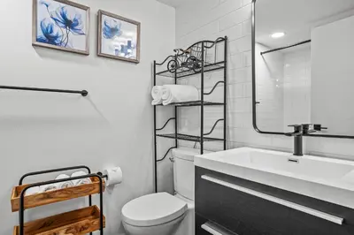 a white bathroom with a toilet and a sink at T202 BRAND NEW! The Mountain's Call- Mountain View Stay in Canmore