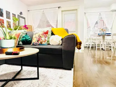 a living room with a couch and a table at Langley Heights 2 Bedrooms Sweet Suite in Langley