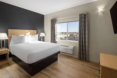 a hotel room with a bed and a window at Baymont by Wyndham West Edmonton in Edmonton
